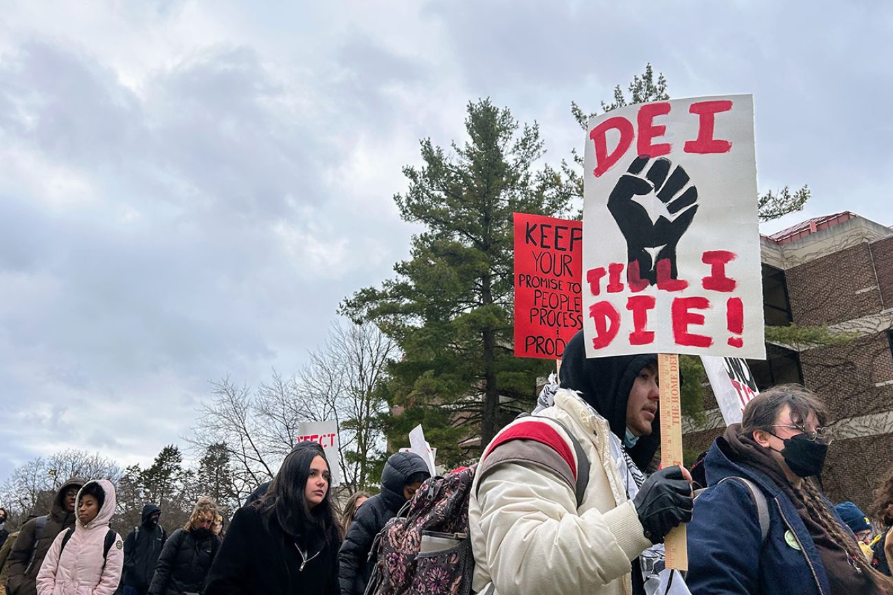 Someone holding a sign that says "DEI until I die!"