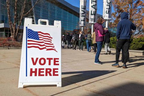 people standing in line to vote