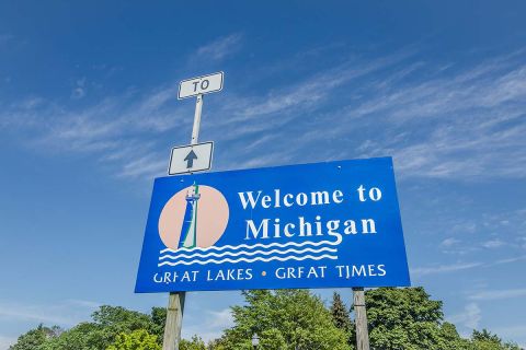 A blue Welcome to Michigan sign