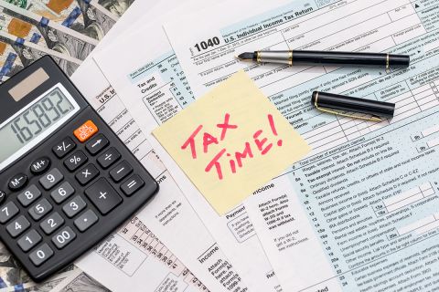tax form with sticker calculator, money and pen business concept