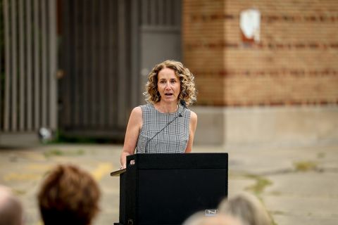 Amy Hovey, director and CEO of the Michigan State Housing Development Authority, at a podium. 