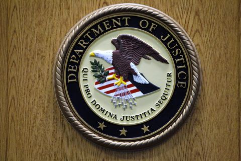 Justice Department logo on the wall. 