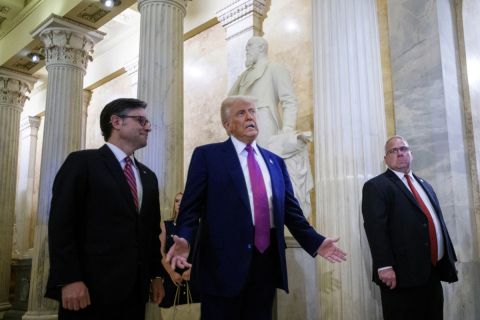 President Donald Trump stands next to Speaker of the House Mike Johnson.
