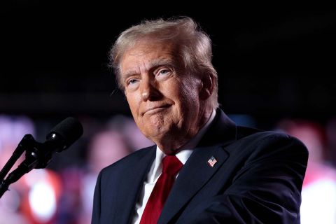 Donald Trump speaking into the microphone. 